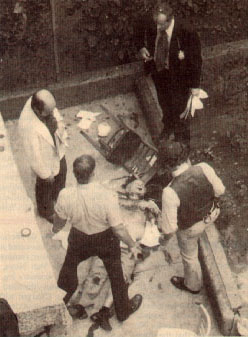 Cops and Agents surround the body of Carmine Galante